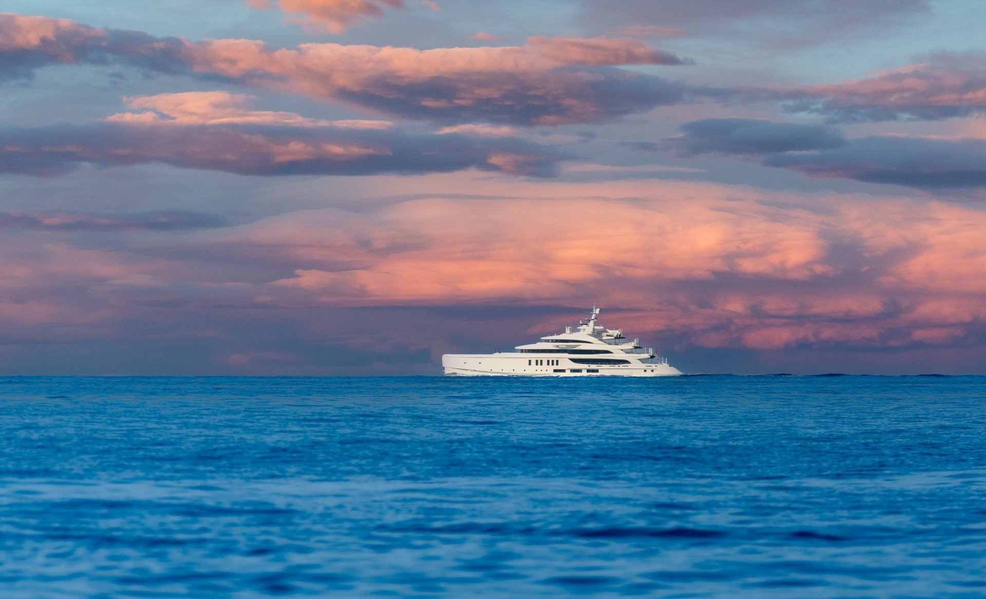 Luxury yacht sailing at sunset