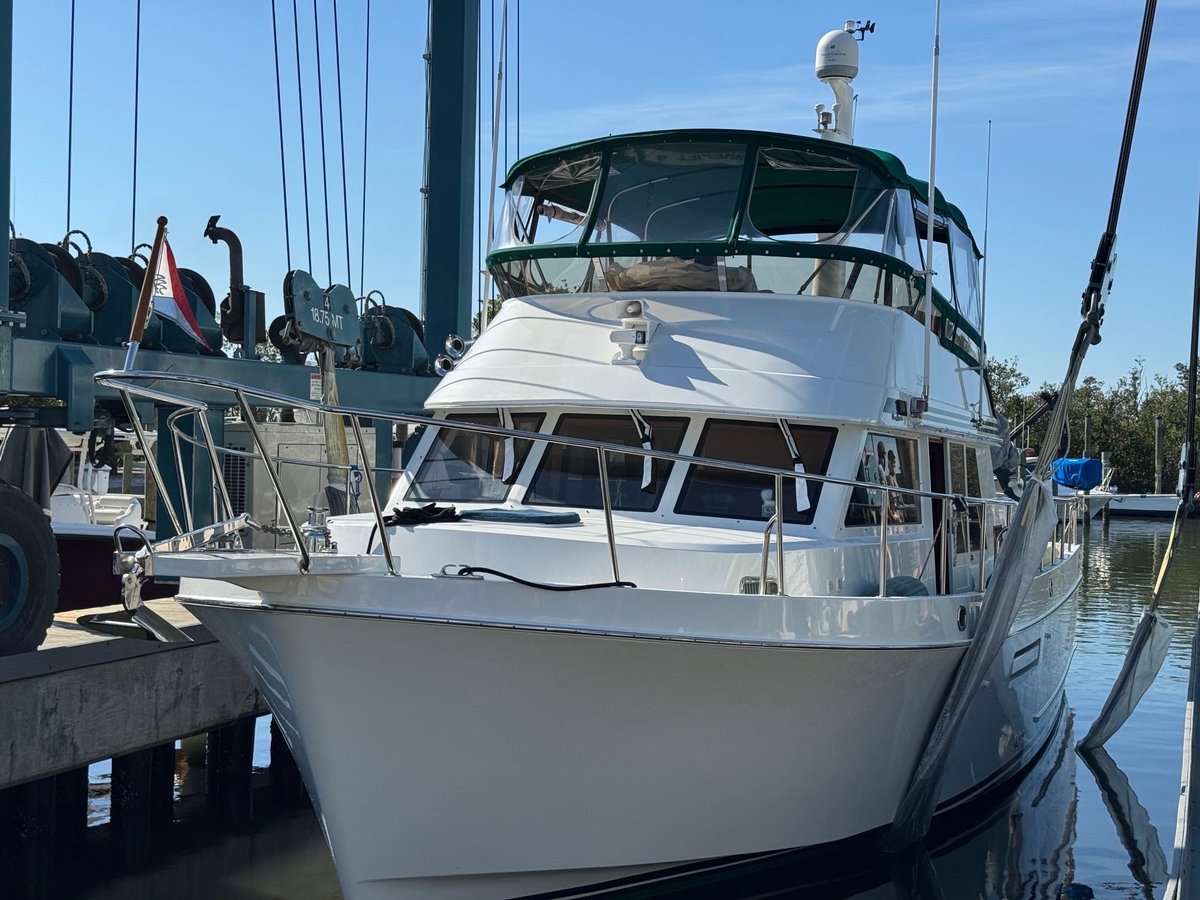 White multi-deck yacht docked at marina